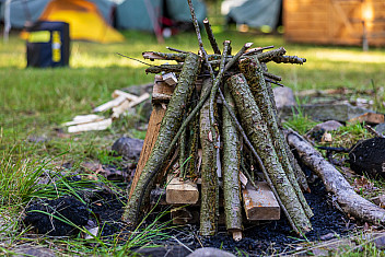 A tepee fire lay of split kindling and sticks built over tinder, ready to light, Camp Aquehonga, Ten Mile River Scout Camps
