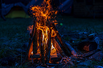 A tepee campfire burning tall at night, Camp Aquehonga, Ten Mile River Scout Camps