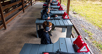 Rifle Range Firing Line at Camp Keowa Scouts in ear protection at the covered firing line of the rifle range at Camp Keowa, Ten Mile River Scout Camps, during the Halloween shooting sports weekend, October 2025