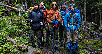 On the Trail in the White Mountains Troop 23 Brooklyn backpackers with packs and trekking poles on a forest trail in the White Mountains, New Hampshire, on the 2023 Adventure Trek