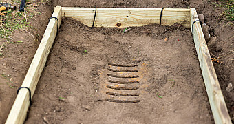 A storm drain dug out and framed with lumber in Shore Road Park near 79th Street, Bay Ridge, during Ty's Eagle Scout project, September 27, 2025