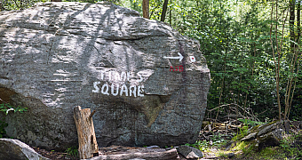 A boulder painted «Times Square» marks a trail junction in Harriman State Park, passed on Troop 23 Brooklyn's backpacking trek, May 25, 2024