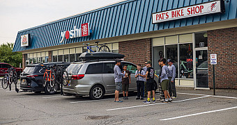The storefront of Pat's Bike Shop on Wilson Street in Brewer, Maine, with Troop 23 Brooklyn's vehicles parked outside on the way north to Baxter State Park, August 10, 2026
