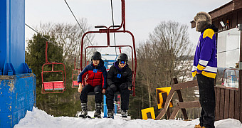 Troop 23 Brooklyn Scouts riding a chairlift on a ski day during the February 2026 winter weekend
