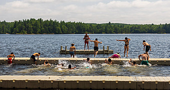 Swimming off the Docks at Camp Yawgoog Swimmers jumping off the docks into the swim area at a Camp Yawgoog waterfront, Rhode Island, July 2025