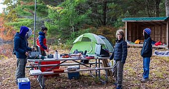Breakfast at the Lakeside Lean-Tos Scouts cooking breakfast at a picnic table beside their tents and a lean-to, Lakeside Lean-Tos site B, Ten Mile River Scout Camps, October 2025